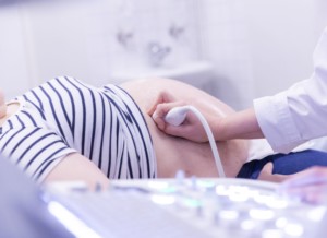 The doctor examines the patient with an ultrasound.